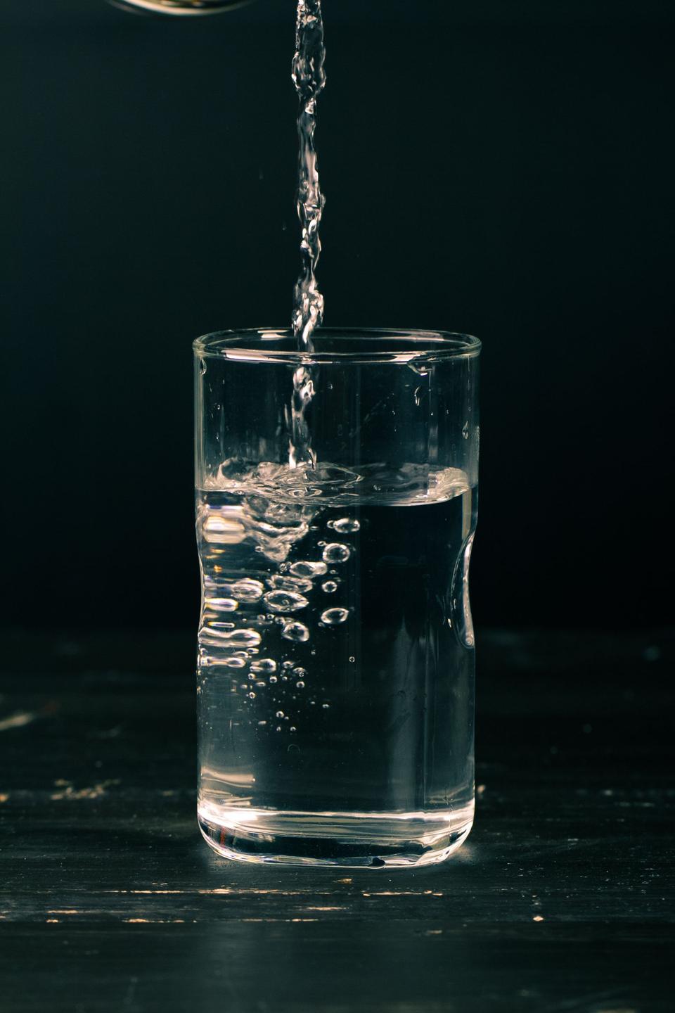 Water being poured into a clear glass